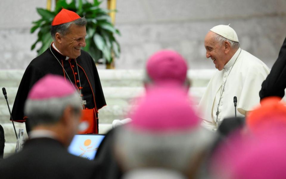 Pope Francis smiles at Cardinal Mario Grech, secretary-general of the Synod of Bishops, as the first assembly of the synod on synodality concludes Oct. 28 in the Paul VI Hall at the Vatican. (CNS/Vatican Media)