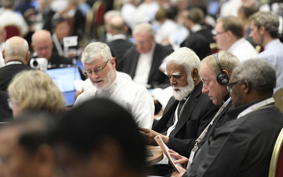 Bishop Shane Mackinlay of Sandhurst, Australia, left, an elected member of the Commission for the Synthesis Report of the assembly of the Synod of Bishops, recites morning prayer with Cardinal Joseph Coutts, retired archbishop of Karachi, Pakistan, center, and Archbishop Michael Miller of Vancouver Oct. 12 in the Paul VI Audience Hall at the Vatican. (CNS/Vatican Media)