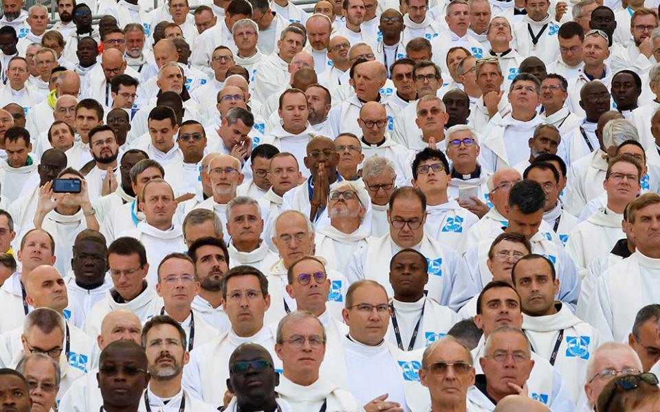 Concelebrating priests pray as Pope Francis presides over Mass at the Vélodrome Stadium in Marseille, France, Sept. 23, 2023. (CNS/Lola Gomez)