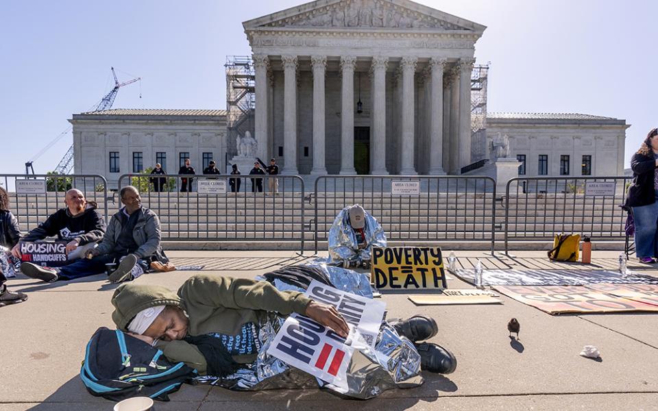 Activists demonstrate at the Supreme Court as the justices consider a challenge to rulings that found punishing people for sleeping outside when shelter space is lacking amounts to unconstitutional cruel and unusual punishment, on Capitol Hill April 22 in Washington. (AP photo/J. Scott Applewhite)