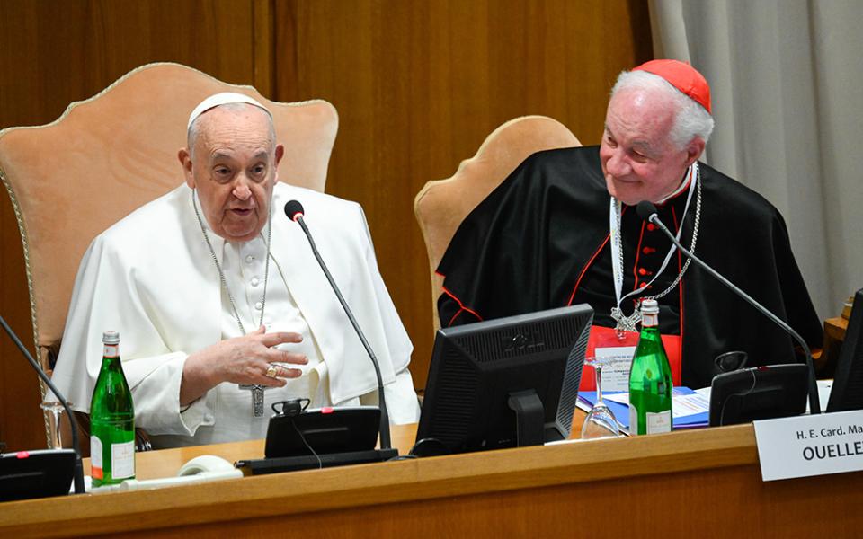Pope Francis, seated next to Cardinal Marc Ouellet, head of the Center for Research and Anthropology of Vocations and former prefect of the Dicastery for Bishops, addresses attendees at an international congress titled, "Man-Woman: Image of God. For an Anthropology of Vocations," March 1 in the Vatican's Synod Hall. (CNS/Vatican Media)