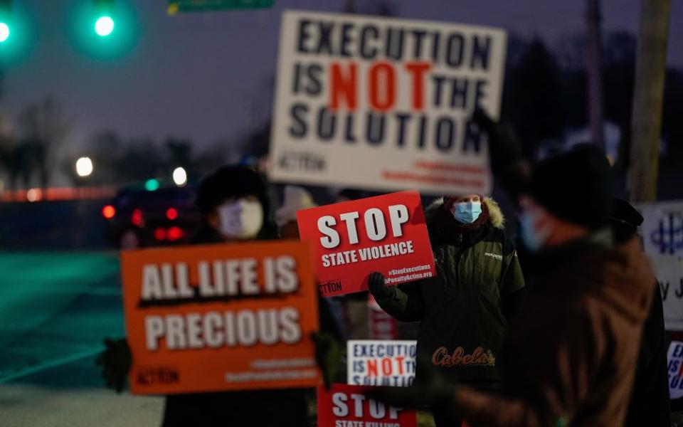 Demonstrators in Terre Haute, Ind., gather to protest the execution of Lisa Montgomery Jan. 12, 2021. She was put to death by lethal injection at the federal prison in Terre Haute, the first woman to be put to death in federal prison since 1953. (CNS/Reuters/Bryan Woolston)