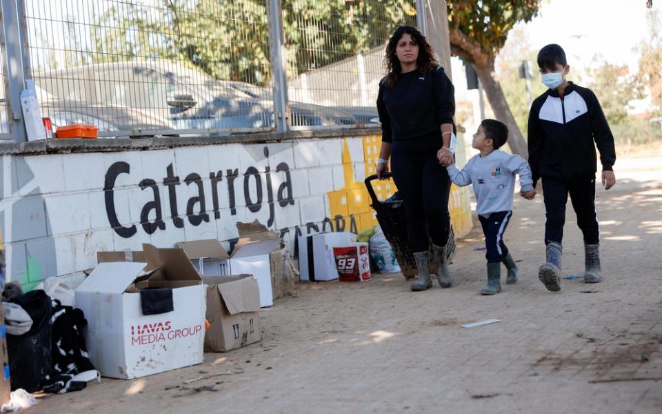 Woman walks with two sons. 