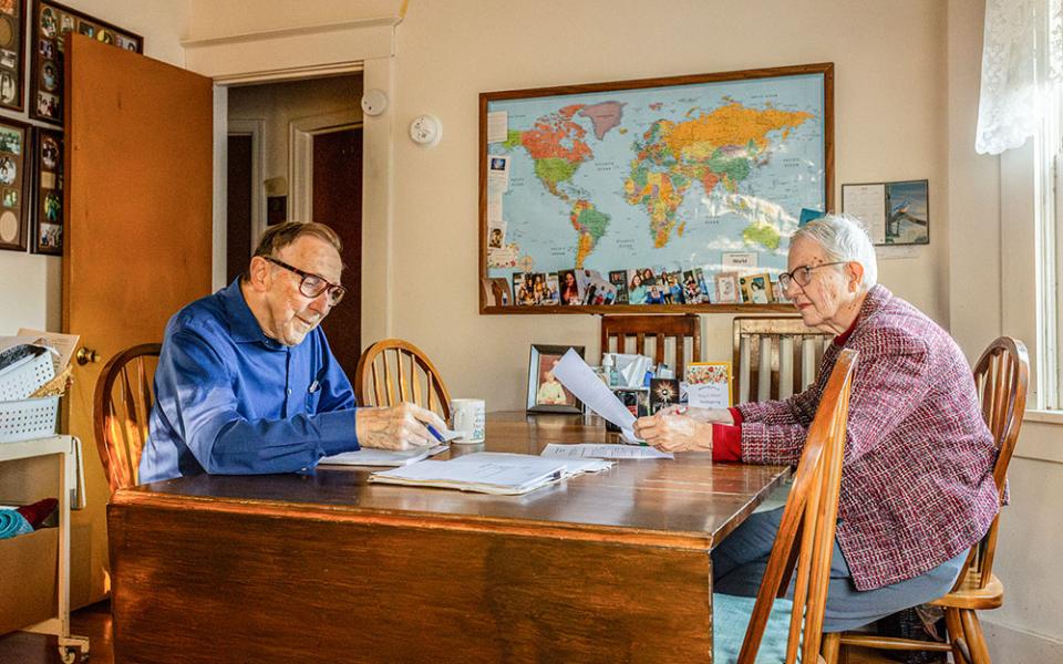 Mel and Mary Ann Beckman work on the Nebraska Criminal Justice Review at their dining room table on Nov. 19, 2024, in Omaha, Nebraska. Mel, who founded the review, handed over editing duties to Jeanie Mezger in 2023. (Flatwater Free Press/Joseph Saaid)