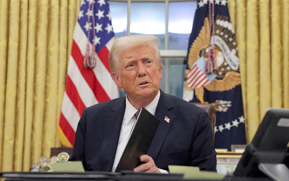 U.S. President Donald Trump signs documents in the Oval Office at the White House on Inauguration Day, Jan. 20  in Washington. He signed a series of executive orders including on immigration, birthright citizenship and climate. Trump also signed an order directing the U.S. government to only recognize two sexes, male and female. (OSV News/Reuters/Carlos Barria)