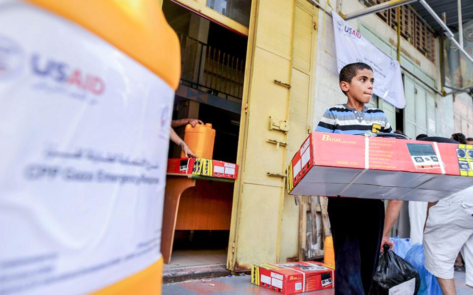 A boy is seen with relief goods at a U.S. Agency for International Development (USAID) distribution center in Gaza City. (OSV News/Shareef Sarhan, for Catholic Relief Services)