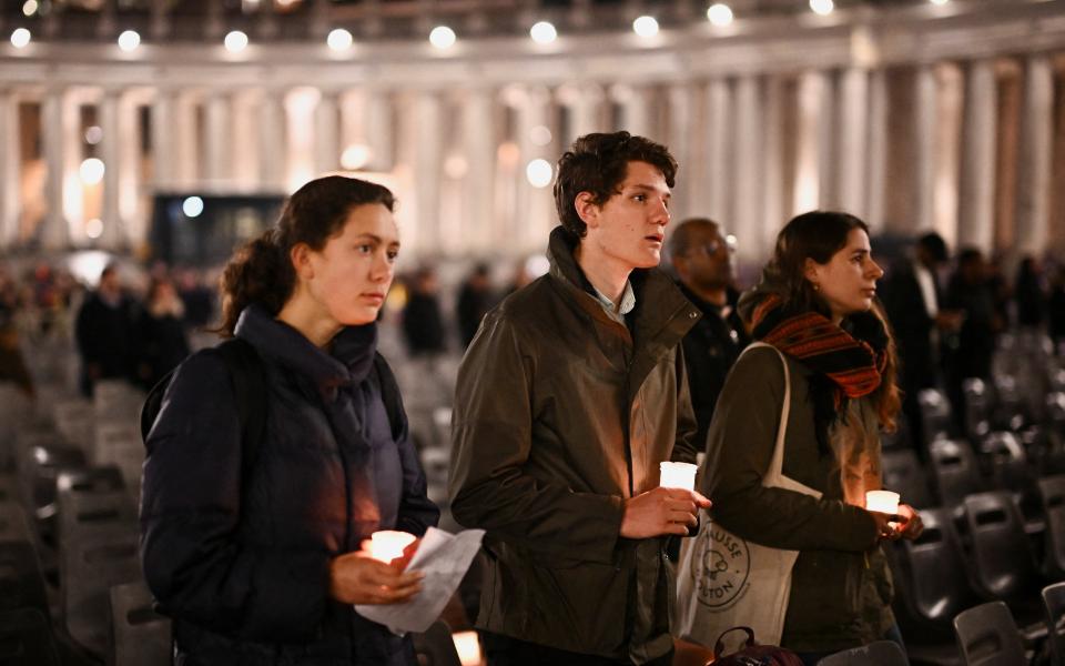 People join in reciting the rosary for Pope Francis in St. Peter's Square at the Vatican Feb. 24, 2025. 