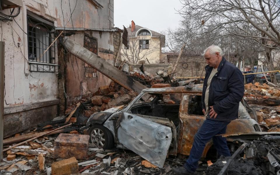 A sad-looking resident is seen walking through rubble at a site of an apartment building in Odesa, Ukraine, which was hit by a Russian drone strike amid Russia's attack on Ukraine.