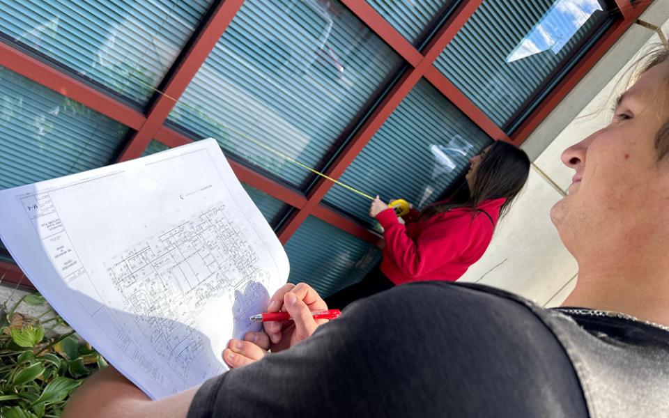 Catholic University of America students take measurements of the pastoral center for the Newark Archdiocese as part of a pilot course providing energy and sustainability recommendations to Catholic dioceses. (Patricia Andrasik)