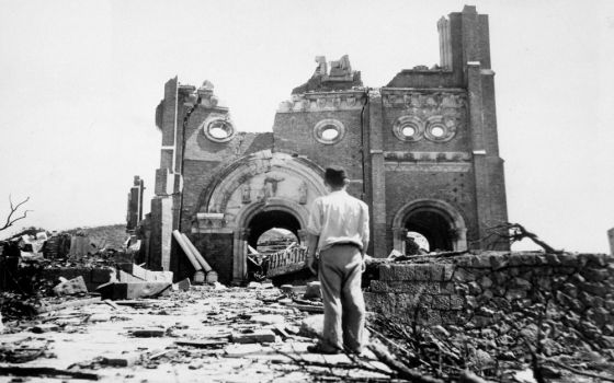 Partial walls of the Urakami Catholic Cathedral in Nagasaki, Japan, stand amid rubble a month after the U.S. detonated an atomic bomb Aug. 9, 1945. (AP/Stanley Troutman)