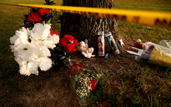 Candles with images of Christ and other items are seen May 20 at a makeshift memorial in memory of the victims killed in a shooting at the Santa Fe High School in Texas. (CNS/Reuters/Jonathan Bachman)