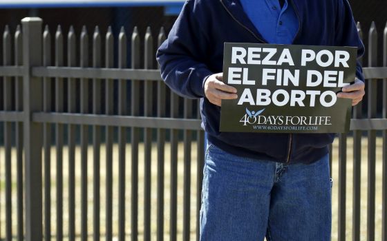 A Spanish-language sign that reads, "Pray for the end of abortion," is seen at a vigil near the entrance to a Planned Parenthood center in Smithtown, New York, March 26. (CNS/Gregory A. Shemitz)