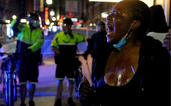 A protester in Boston screams after being affected by a chemical agent used by metro police May 31. (CNS/Reuters/Brian Snyder)