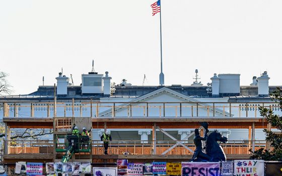 Workers construct a viewing stand in front of the White House Nov. 28, 2020, ahead of the presidential inauguration ceremonies Jan. 20, 2021, in Washington. (CNS/Reuters/Erin Scott)