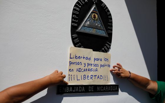 Women hold a poster that reads "Freedom to all political prisoners in Nicaragua, FREEDOM!" during a protest in front of the Nicaraguan embassy in San Salvador, El Salvador, June 30, 2021, to demand an end to repression and the release of political prisone