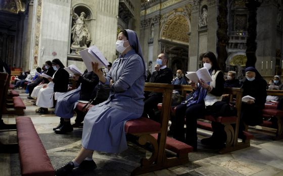 People wear protective masks as Pope Francis celebrates a Mass in St. Peter's Basilica at the Vatican May 16, 2021. Italy is requiring proof of vaccination to enter a variety of indoor areas, including restaurants and movie theaters, but the Italian bisho