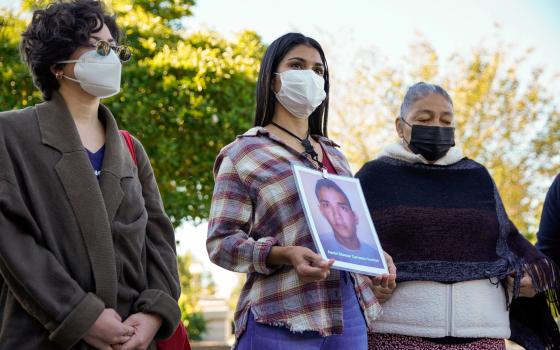 Karen Morales of Honduras talks about her brother, Aaron Eleazar Carrasco Turcios, who went missing nine years ago in Mexico, while standing with other women with the Caravan of Mothers of Disappeared Migrants on Capitol Hill in Washington Oct. 19, 2021. 