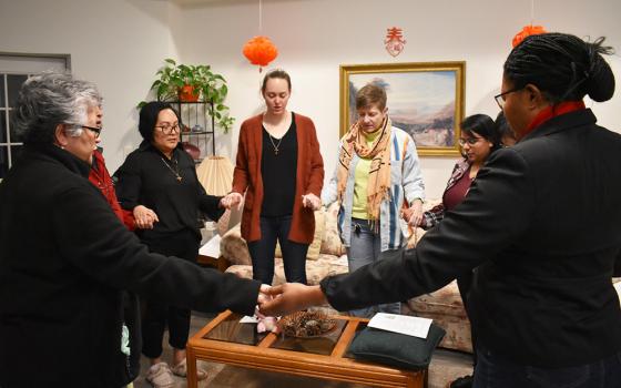 At the conclusion of evening prayer at the InterCongregational Collaborative Novitiate in Chicago, the novices and the codirectors gather to simultaneously recite the Lord's Prayer in their native language. (Julie A. Ferraro)