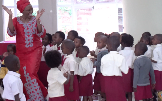 Maggy Barankitse dances with children at her humanitarian organization in Burundi.