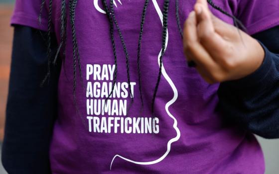 Graphic on t-shirt shown, worn by woman with long braids. 