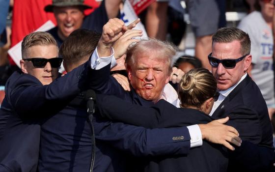 Republican presidential candidate and former U.S. President Donald Trump is assisted by security personnel after gunfire rang out during a campaign rally at the Butler Farm Show in Butler, Pennsylvania, July 13, 2024. (OSV News photo/Brendan McDermid, Reuters)