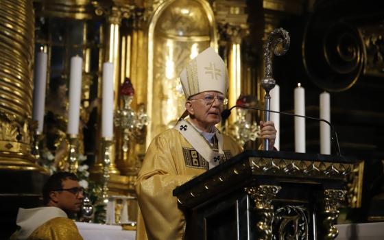 Archbishop, vested in gold, preaches. 