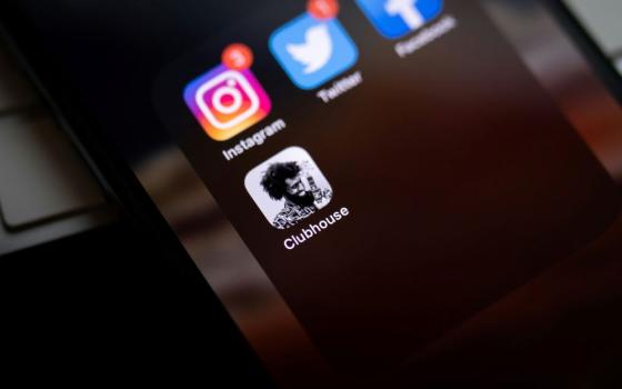 Social media logos appear on cellphone screen.