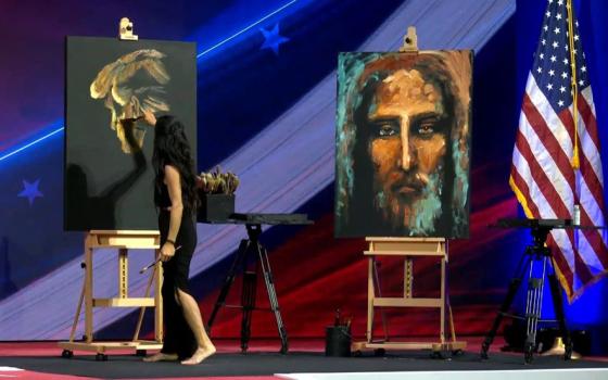 An artist on stage painted an image of former president Donald Trump and an image of the face of Christ, before the Conservative Political Action Conference's annual Ronald Reagan Dinner, Feb. 23. 
