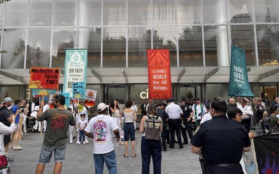 Interfaith environmental protestors blocked the entrance doors of Citigroup’s headquarters in downtown New York on July 30. (NCR photo/Camillo Barone)
