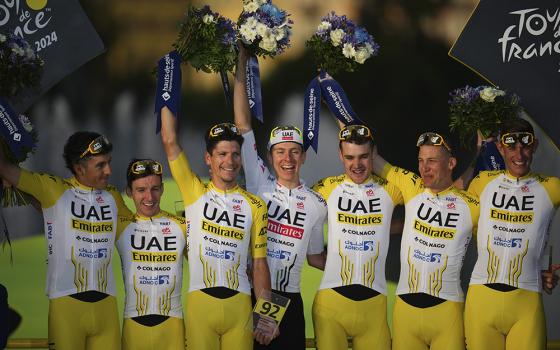 Tour de France winner's Tadej Pogačar, center, and his UAE Team Emirates were awarded the best team after the 21st stage of the Tour de France cycling race, an individual time trial over 33.7 kilometers (20.9 miles) with start in Monaco and finish in Nice, France, July 21, 2024. (AP/Daniel Cole)