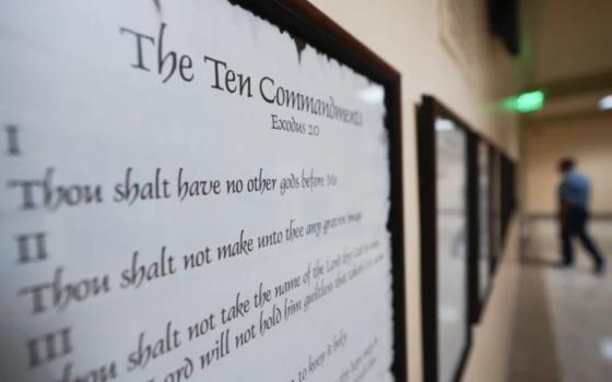 Ten Commandments written on plaque hanging on wall. 
