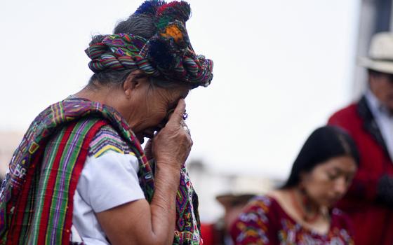 Ana de Leon, from the Maya Ixil people and a survivor of the internal armed conflict, reacts while participating with others in a ritual, outside the Supreme Court and prior to a hearing in the Maya Ixil genocide trial, March 25 in Guatemala City, Guatemala. (OSV News/Reuters/Cristina Chiquin)