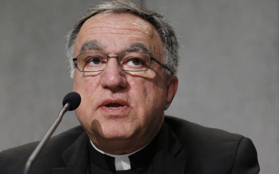 Close-up of Rosica in front of a microphone. 