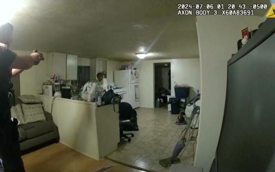 In this image taken from body camera video released by Illinois State Police on July 22, former Sangamon County Sheriff's Deputy Sean Grayson, left, points his gun at Sonya Massey, who called 911 for help, before shooting and killing her inside her home in Springfield, Ill., July 6. (Illinois State Police via AP)