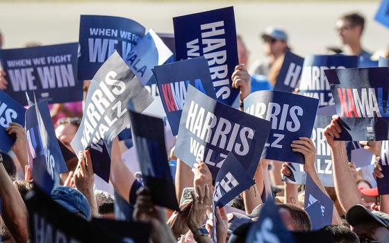 Supporters hold signs before Democratic presidential nominee Vice President Kamala Harris and her running mate Minnesota Gov. Tim Walz arrive for a campaign rally Aug. 7 in Romulus, Michigan. (AP/Carlos Osorio)