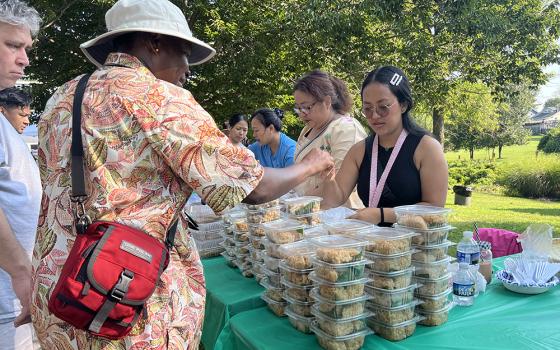 New and longtime parishioners share food at the first Burmese food fair at Our Lady of Victory parish in Baltimore. Burmese parishioners made dishes such as coconut sticky rice for the fundraiser. Many Burmese refugees have found a home at the parish after escaping persecution in Myanmar. (Matt Palmer)