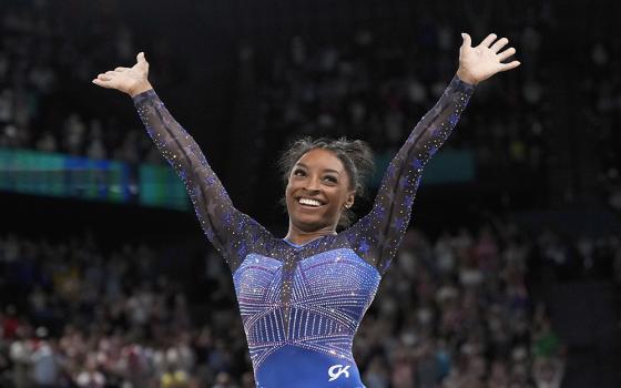 Simone Biles, of the United States, celebrates after performing in the floor exercise during the women's artistic gymnastics all-around finals in Bercy Arena at the 2024 Summer Olympics, Aug. 1 in Paris, France. (AP photo/Charlie Riedel)