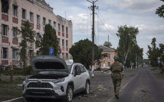 A Ukrainian soldier walks past at a city hall in Sudzha, Kursk region, Russia, on Aug. 16, 2024. The Associated Press noted that this image was approved by the Ukrainian Defense Ministry before publication. (AP photo)