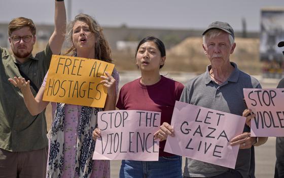 A delegation of U.S. Christians hold an Aug. 18 prayer vigil at the Kerem Shalom crossing on the border between Israel and Gaza. The group came to the Middle East to accompany threatened Christians and other Palestinians and call for a cease-fire in Gaza. (OSV News/Paul Jeffrey)