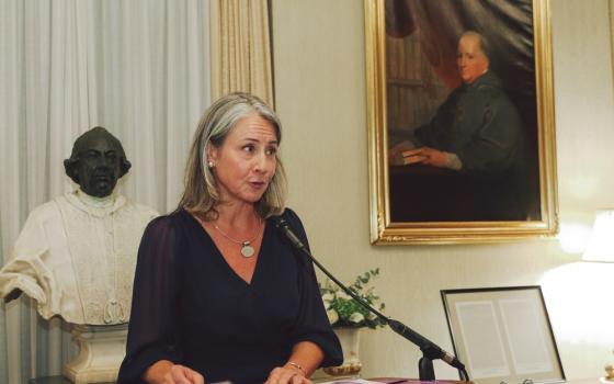 Vaillancourt Murphy stands at a podium delivering remarks. 