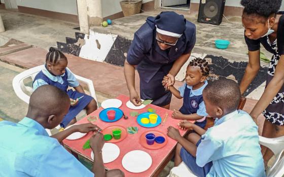 St. Louis Sr. Christie Udebor, center, supports students in a leaf painting activity at the Community Based Rehabilitation Center in Akure, Ondo state, Nigeria. (Courtesy of Christie Udebor)