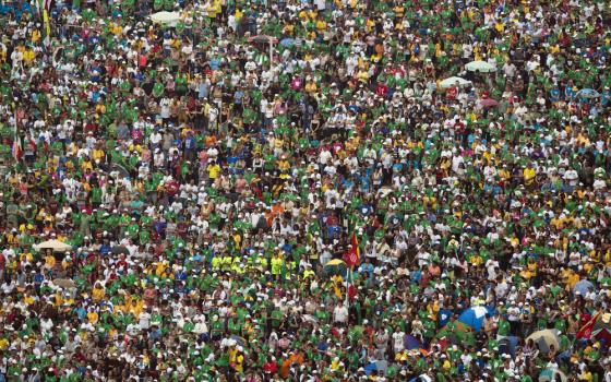 Aerial view of enormous crowd; individuals virtually indiscernible.   