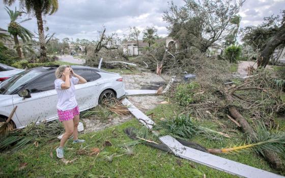 Marie Cook reacts to the damage to her home in Wellington, Fla., Oct. 10, 2024, after a tornado formed by Hurricane Milton touched down striking homes in the neighborhood and surrounding area. (OSV News photo/Bill Ingram/Palm Beach Post/USA Today Network via Reuters)