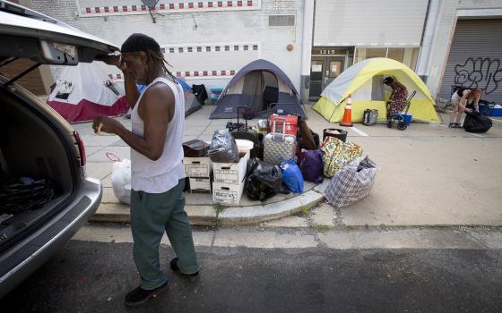 Rows of tents on sidewalk.