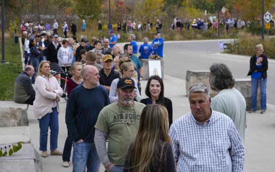 Long line of people on sidewalk.