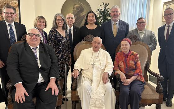 Pope seated surrounded by small group. Gramick and DeBernardo sit on his right and left.