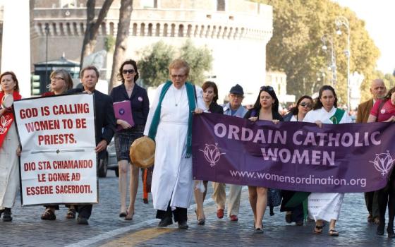 Then Maryknoll Father Roy Bourgeois, third from left, marches down Via della Conciliazione toward the Vatican during a demonstration calling for women's ordination in Rome Oct. 17, 2011. In 2012, he was expelled from the priesthood and the Maryknoll community because of his public support for women's ordination. (CNS/Paul Haring)