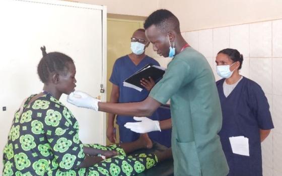 A Catholic Health Training Institute nurse trainee takes a practical exam at St. Daniel Comboni Catholic Hospital, with Sr. Bindhu George, a gynecologist and principal at the Wau, South Sudan college. (Courtesy of Scholasticah Nganda)