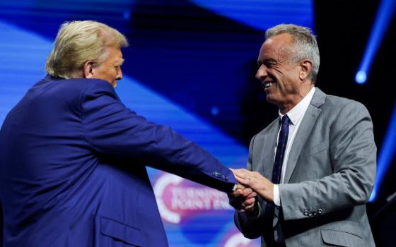 Robert F. Kennedy Jr. and then Republican presidential candidate Donald Trump greet each other at a campaign event in Duluth, Ga., Oct. 23. 