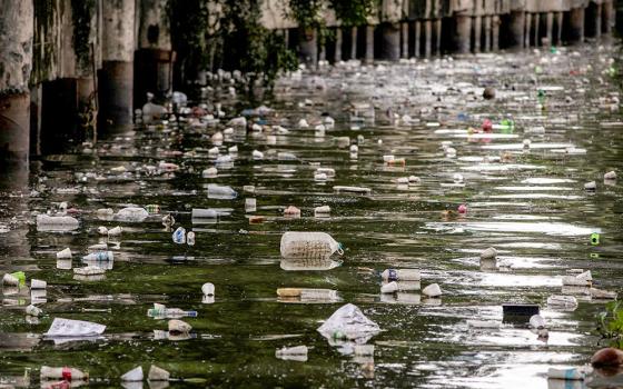 Plastic bottles float on the heavily polluted San Juan River, a tributary of Pasig River in Mandaluyong City, Philippines, June 21, 2021. (OSV News/Reuters/Eloisa Lopez)